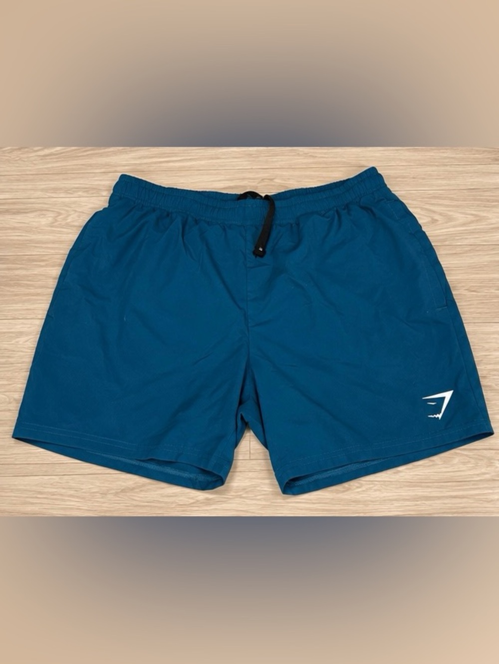 Gymshark men’s lightweight athletic training shorts in teal blue.